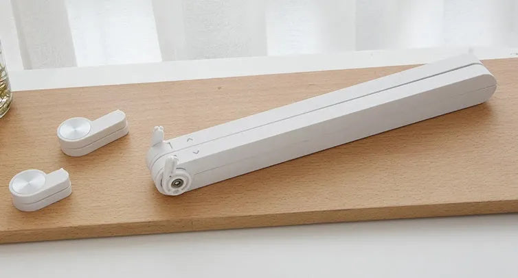 White portable laptop bracket with heat sink base in folded position.