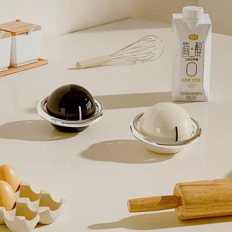 Beige mechanical kitchen timer with manual twist dial and magnetic back on metal surface