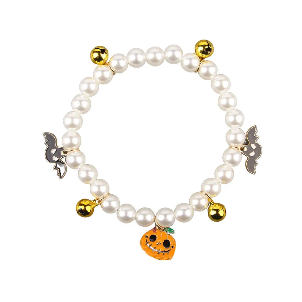 Simulated pearl necklace pet collar decoration with a pumpkin charm for Halloween.