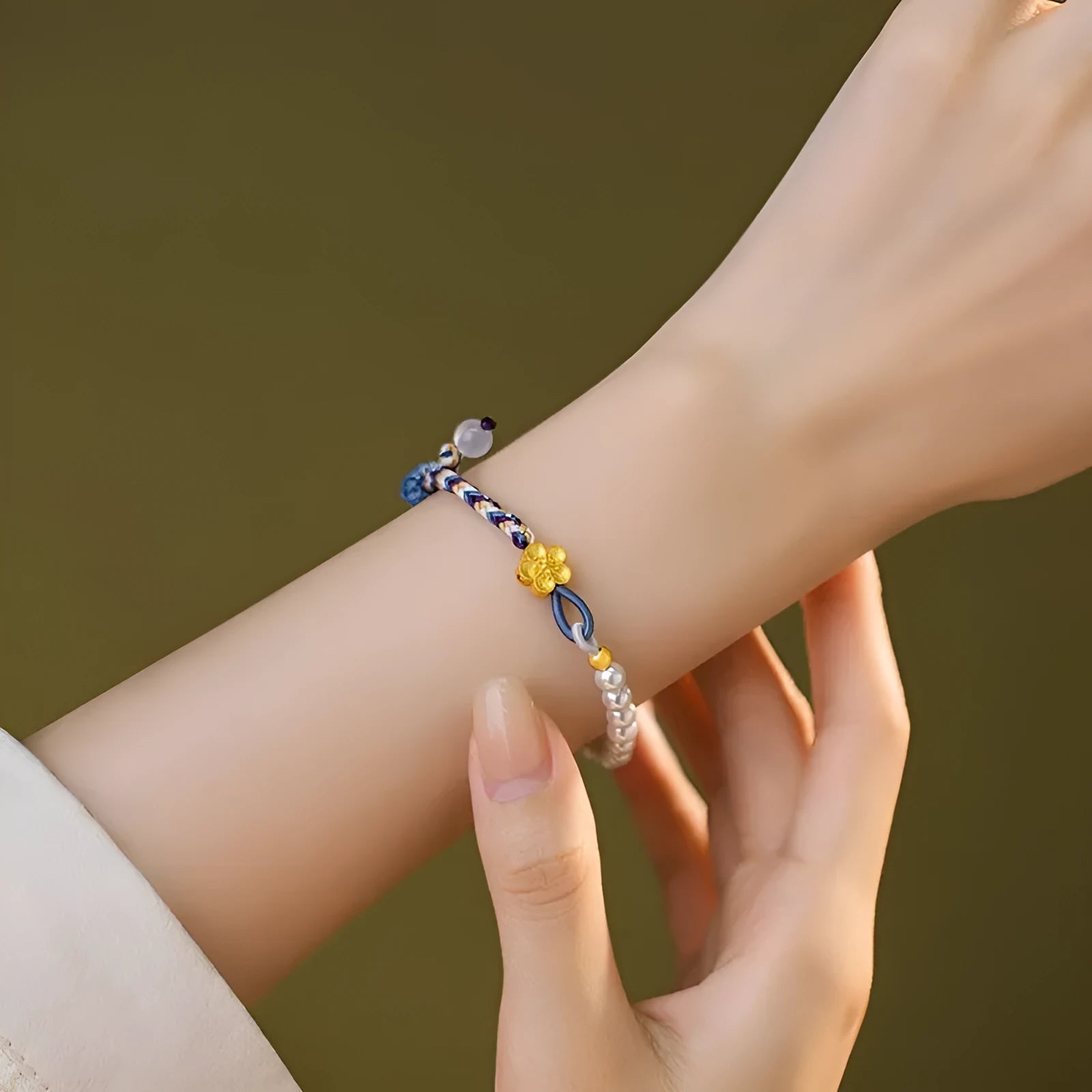 Peach-coloured carrying strap bracelet with Chinese flower weaving pattern featuring sterling silver and chalcedony beads