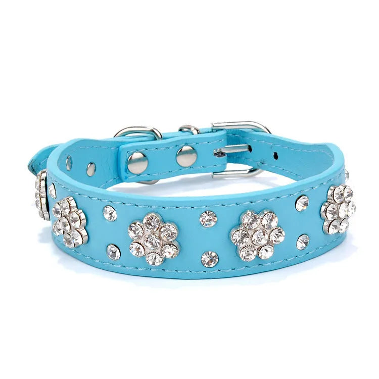 Black dog collar with shiny rhinestone flower pattern and metal D-ring on a soft PU leather strap.