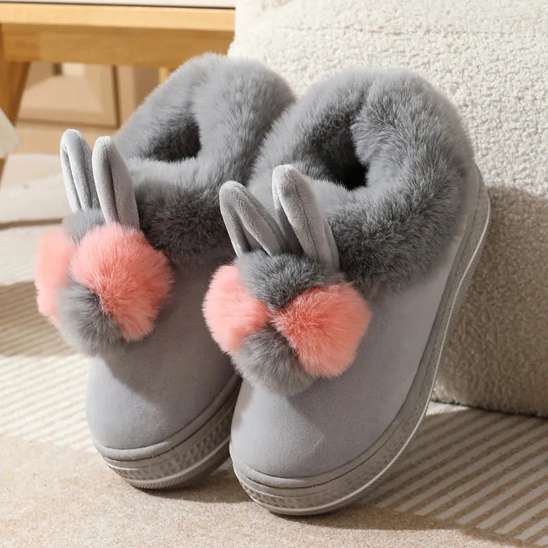 Pair of grey cotton plush high heel slippers with a thick TPR sole, shown on a wooden floor.