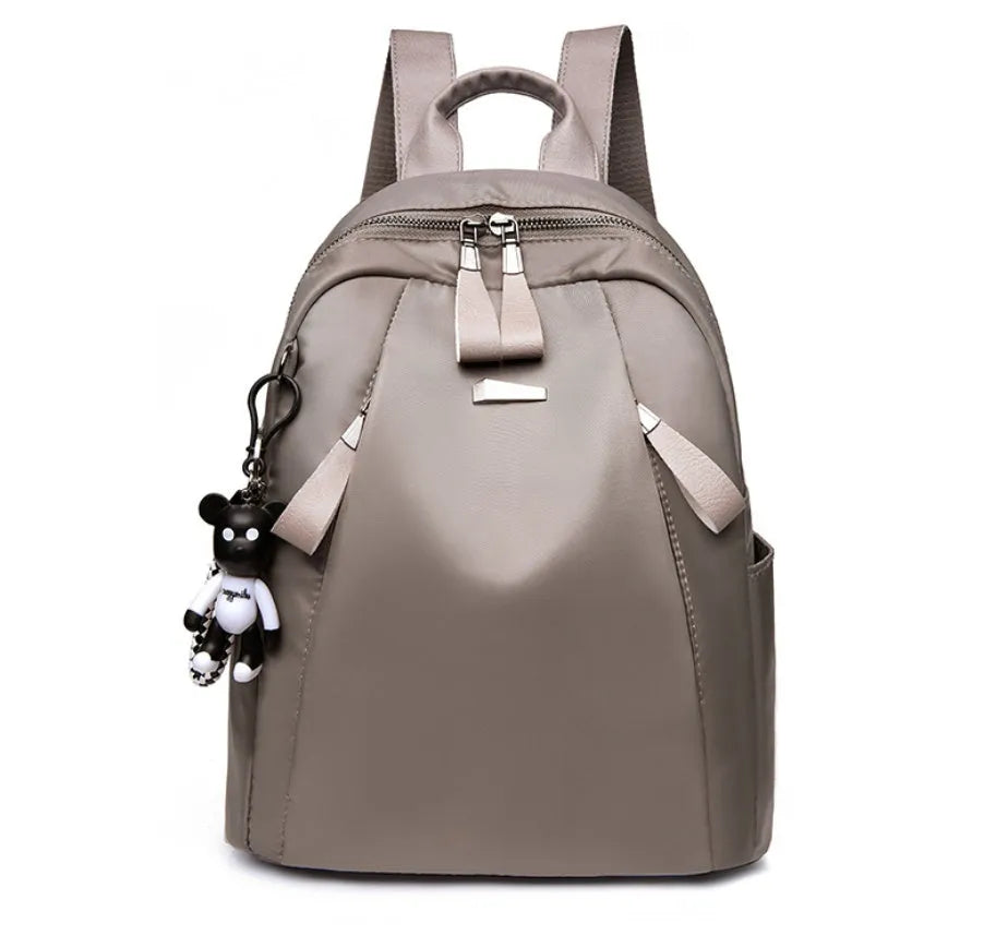 Medium-sized Oxford cloth rucksack in grey with double shoulder straps and a top handle.