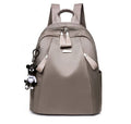 Medium-sized Oxford cloth rucksack in grey with double shoulder straps and a top handle.