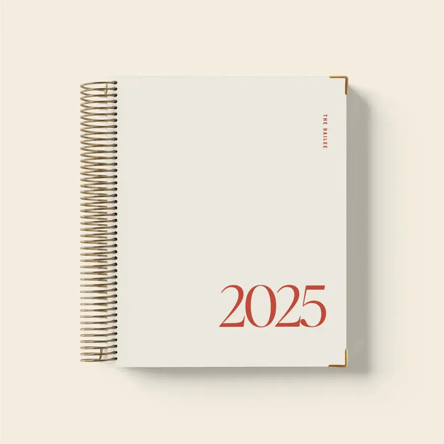 Cherry red daily schedule coil notebook with spiral binding open to show planning pages