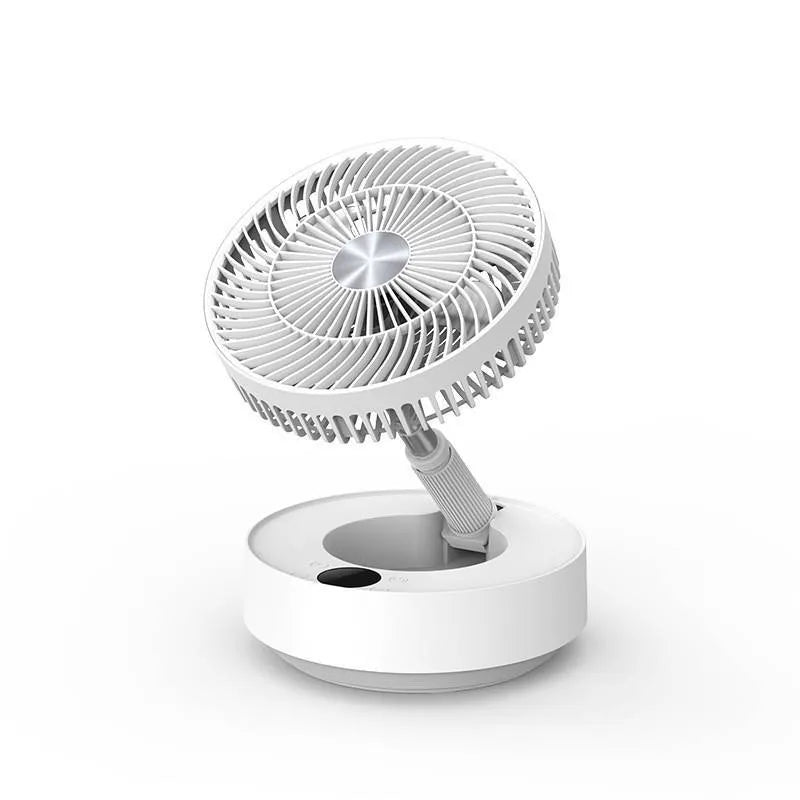 Green telescopic floor fan extended to full height with remote control resting beside base