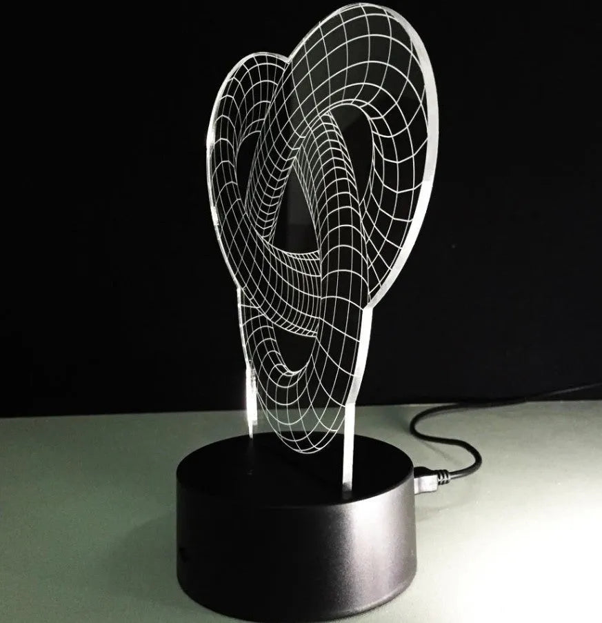 Knot 2 3D optical illusion LED lamp hologram with remote control and touch operation on a table