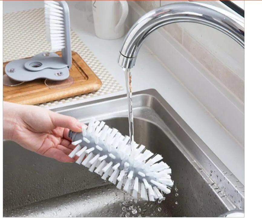 Grey rotating double-headed cup brush with suction cups for wall attachment
