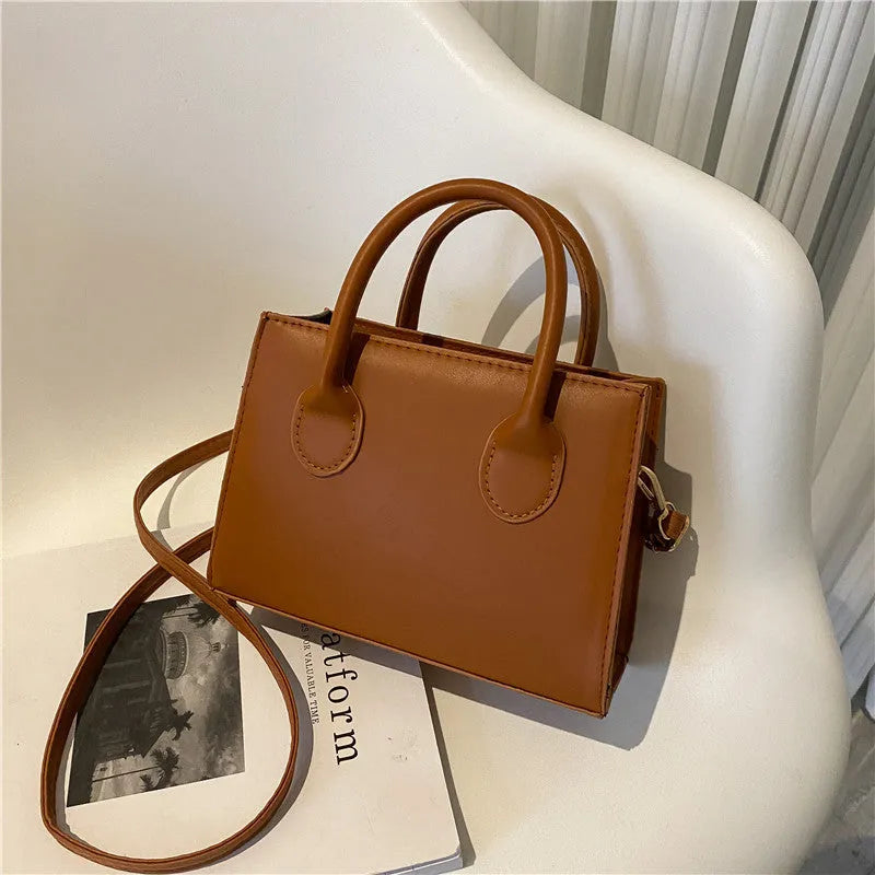 PU synthetic leather small horizontal square shoulder bag in five colour options showing document pocket and single strap