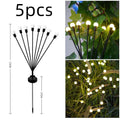 Solar powered LED ground spike garden light with multiple warm white and colour LED heads on stainless steel stake.