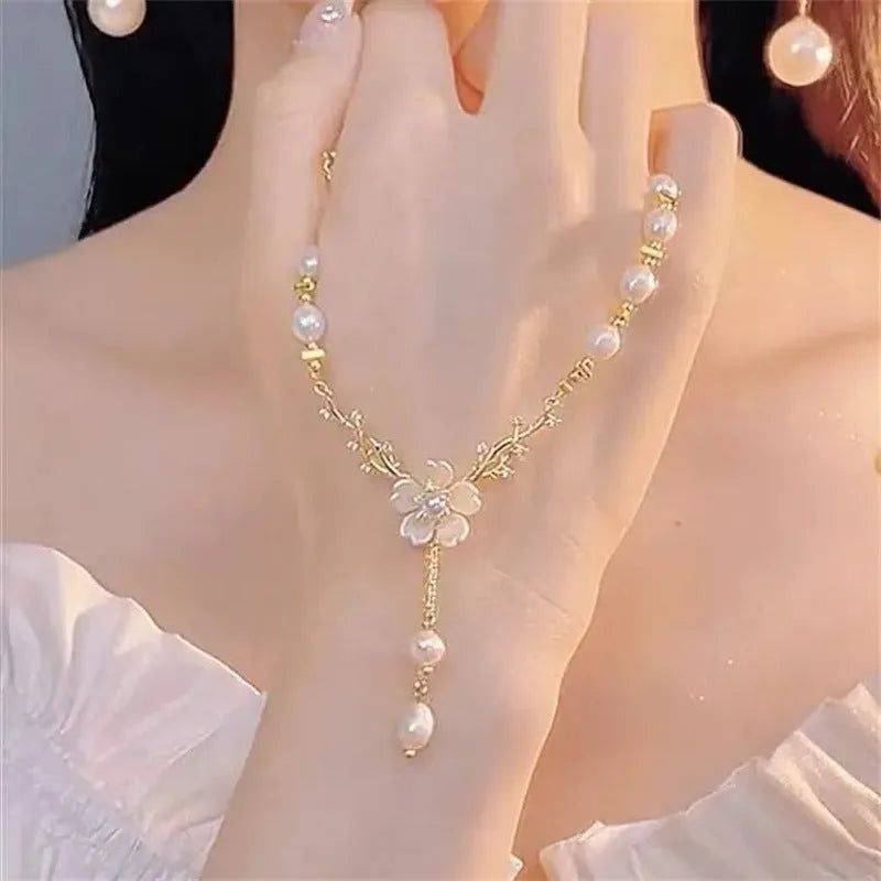Women's alloy necklace with pearl flower design and rose accents on pearl chain