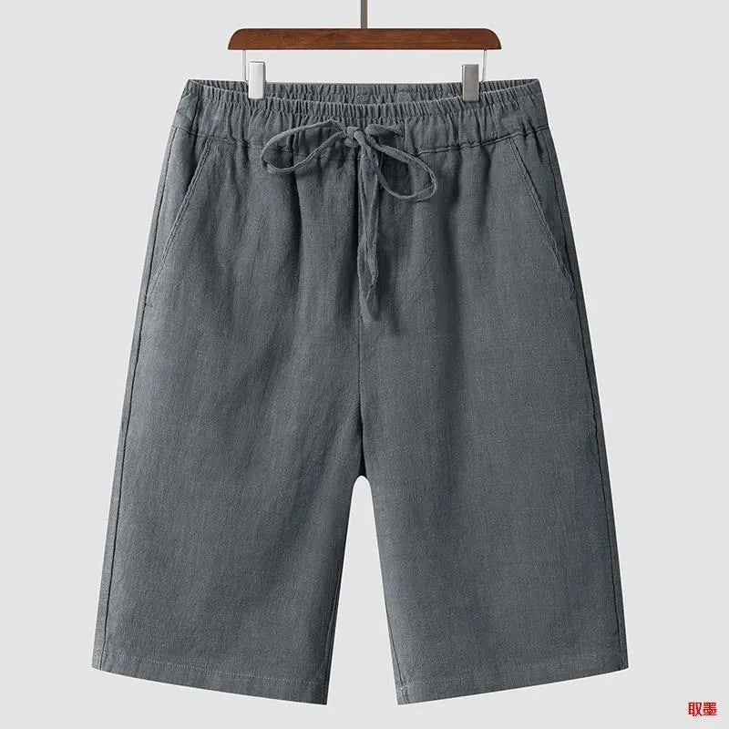 Man wearing beige loose-fit linen cropped shorts with an elastic mid waist.