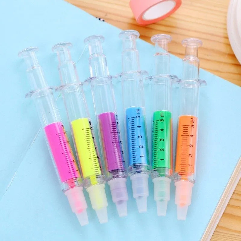 Six syringe-shaped fluorescent highlighter pens in red, orange, blue, yellow, green, and purple with oblique brush tips