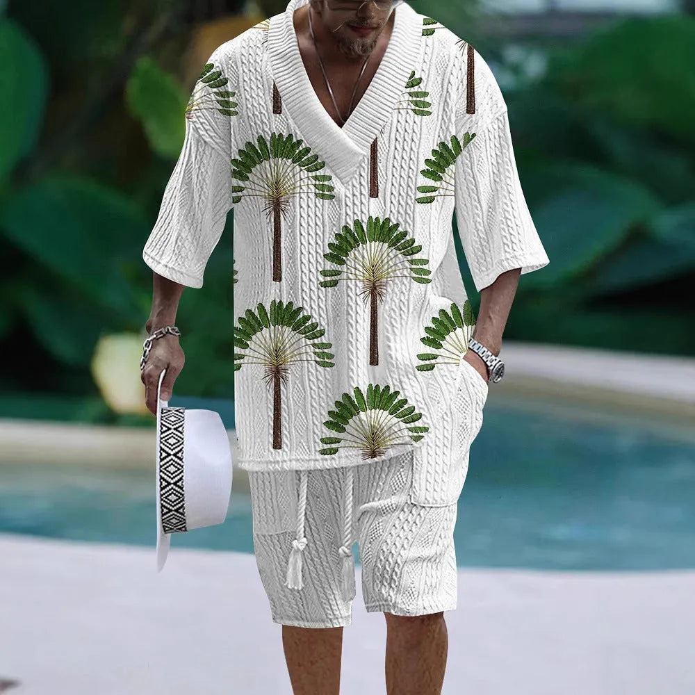 Man wearing a loose-fitting light blue short sleeve suit top and matching shorts, a casual two-piece set.