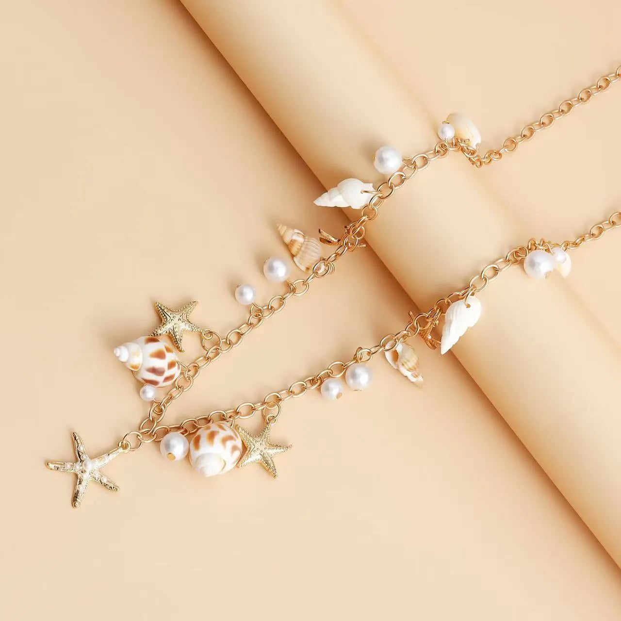 Women's waist chain and matching bracelet set with star-shaped alloy detailing on white background