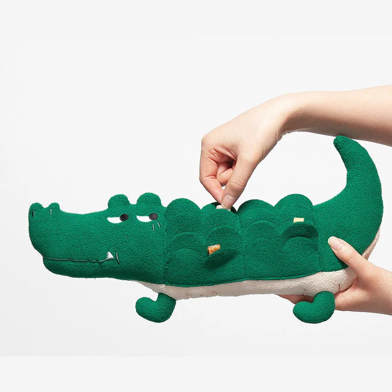 Green plush stuffed toy dog on a white background.