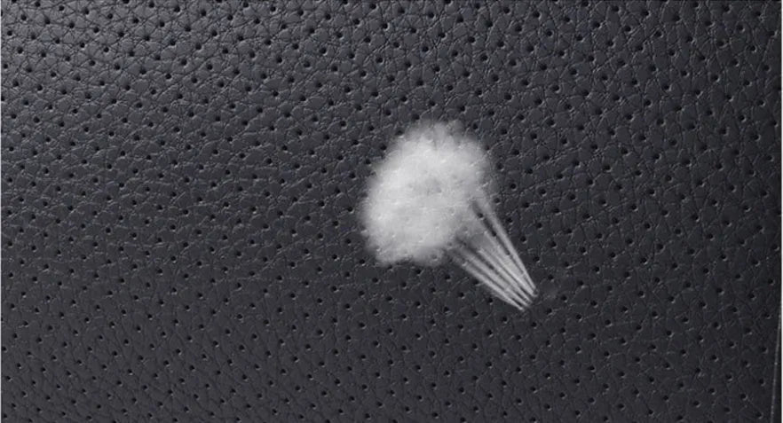 Breathable car headrest with leather cover, down yarn filling, and classic punched ventilation pattern