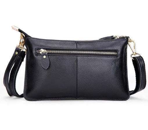 Lady cowhide slant bag showing hand strap and shoulder strap options with organised internal compartments