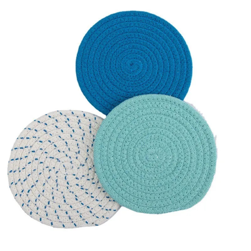 Three round cotton cord coasters in different colours showing 18cm diameter size