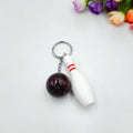 Mini bowling sports keychain pendant in four colour options: dark red, blue, purple, green
