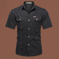 Men's loose fit cotton work shirt in army green with short sleeves and button front.