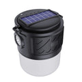 Portable solar camping lantern speaker with Bluetooth, LED light, USB rechargeable, black colour, on outdoor lawn
