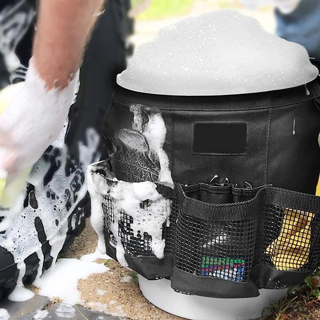 Black cylindrical buggy storage bag hanging from a 5 gallon barrel with car washing tools inside