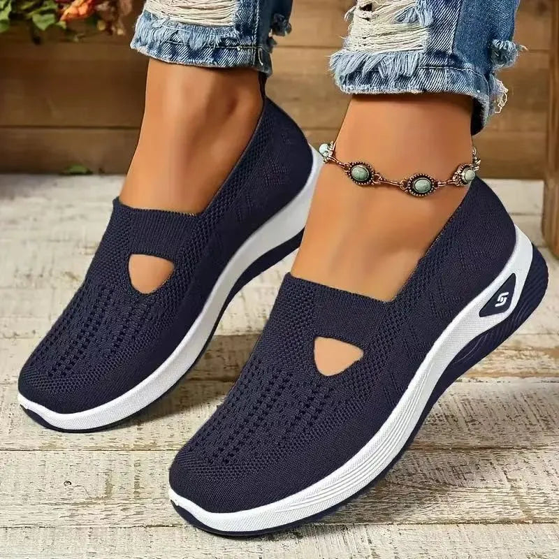Women's light grey mesh casual flats with a T-strap and round toe on a soft PVC sole.