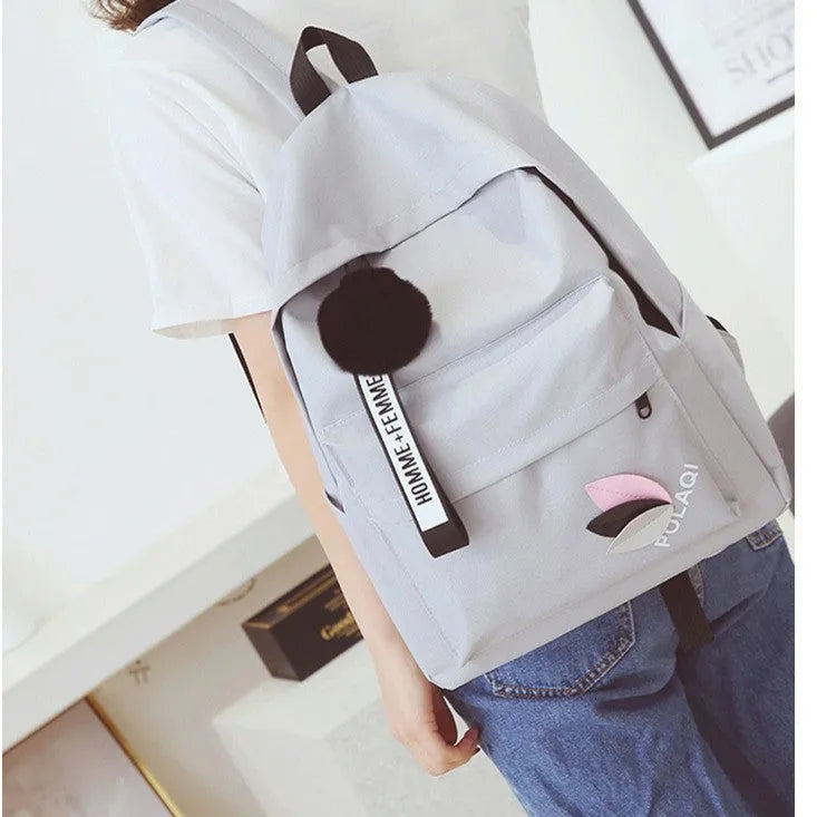 Green canvas college style schoolbag with structured design showing 40cm height and front compartment