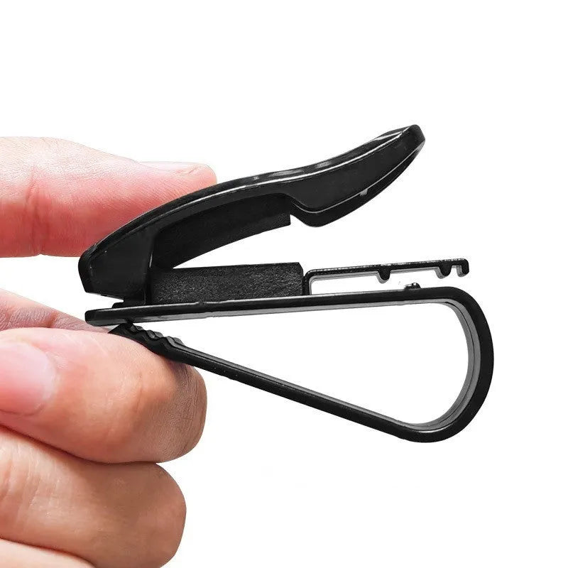Black plastic clip for car sunshade to hold sunglasses and cards, dimensions 6.5 by 2.3 cm.