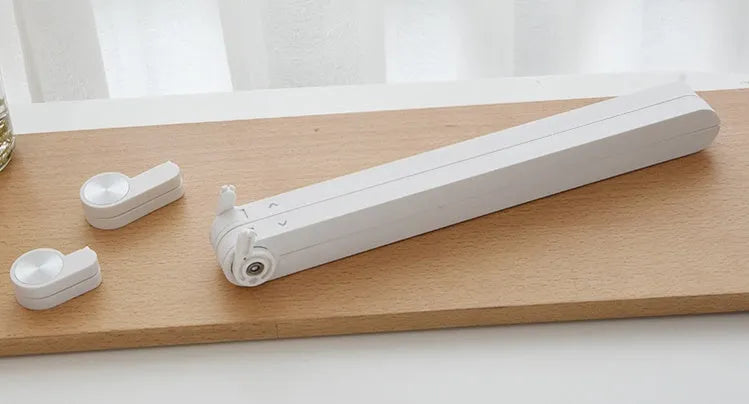 White portable laptop bracket with heat sink base in folded position.