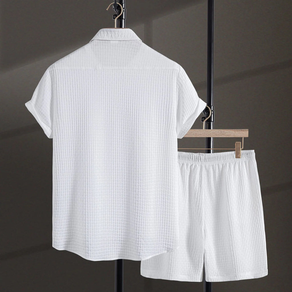 Men's white cotton blend beach shirt and shorts suit set laid flat showing cardigan style and short sleeves