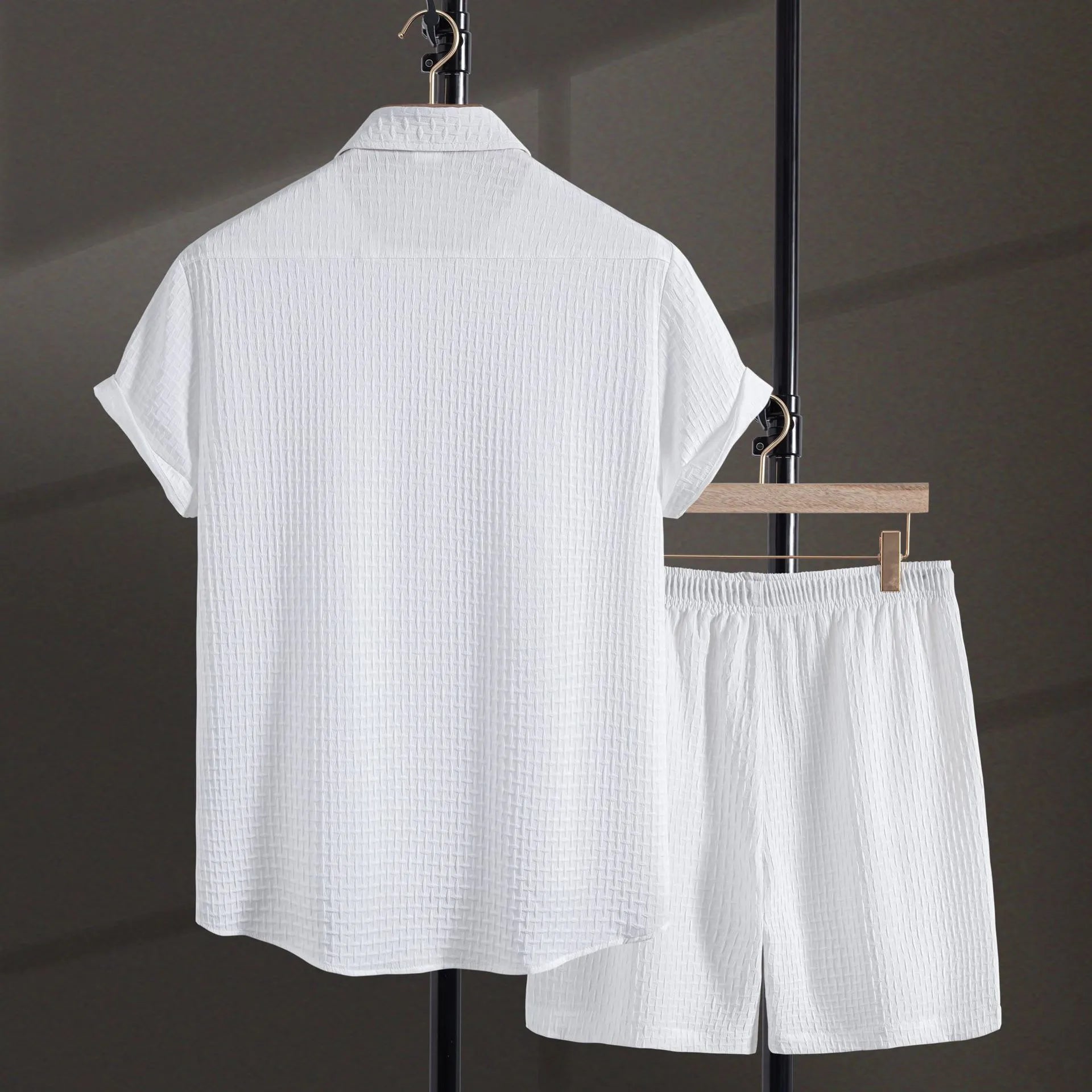 Men's white cotton blend beach shirt and shorts suit set laid flat showing cardigan style and short sleeves