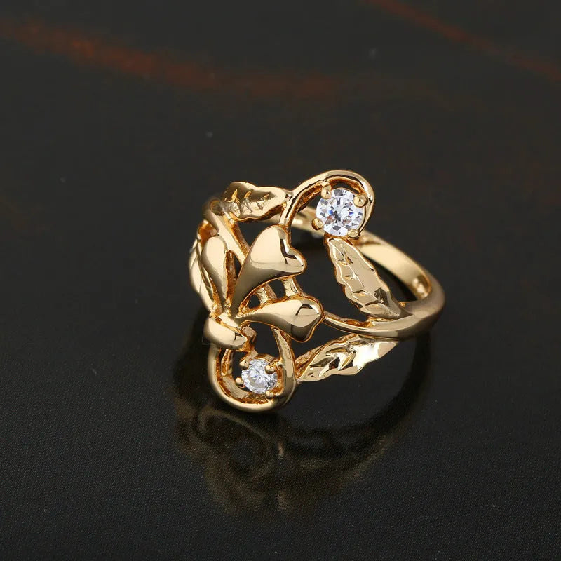 Gold tone copper ring with irregular leaf shape and white zircon crystal on geometric band, women's fashion jewellery