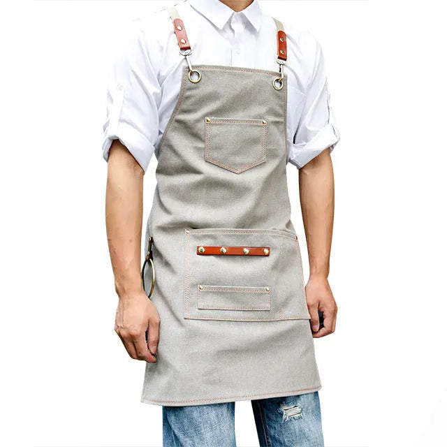 Canvas work apron with cross-back straps in camel colour for cafe and baking use