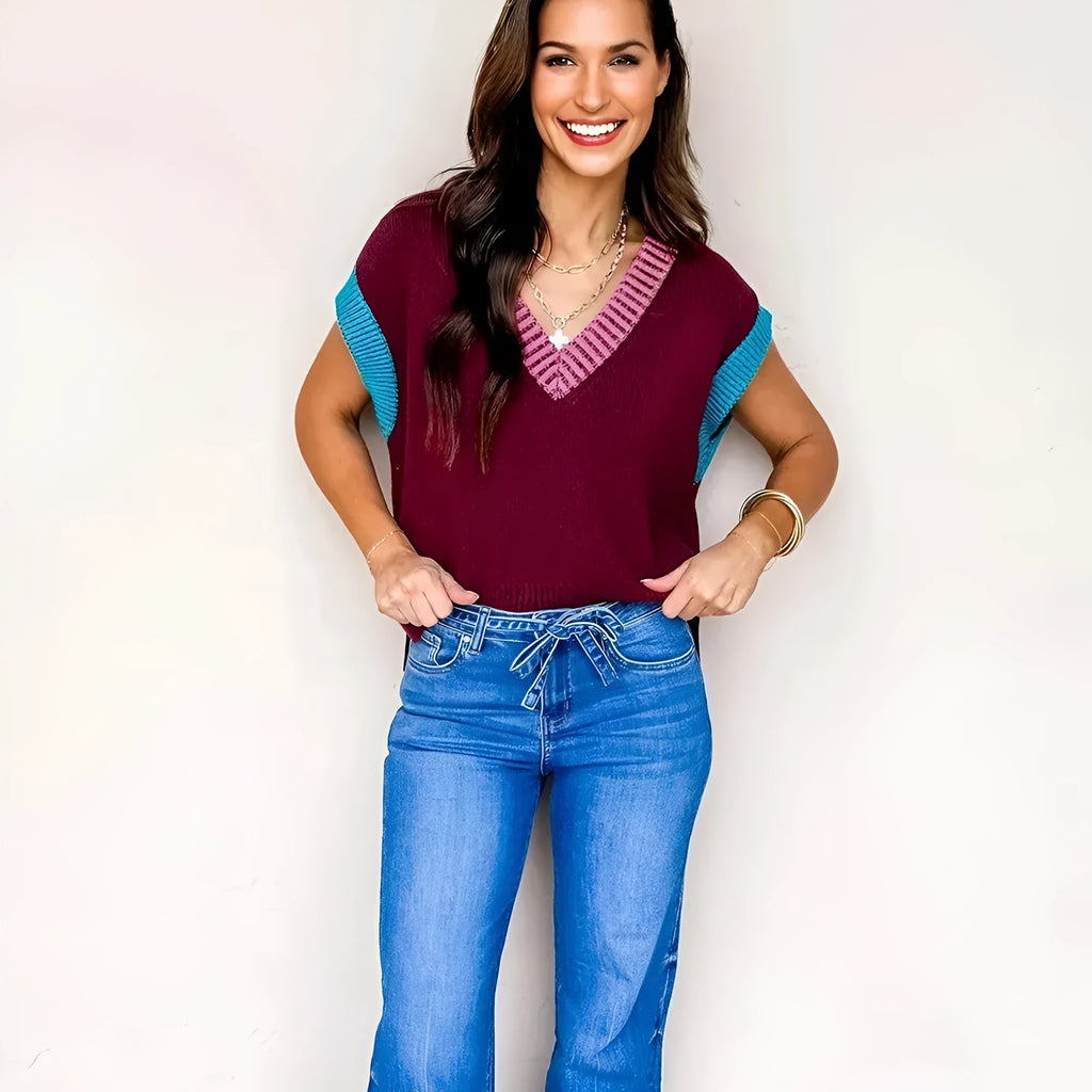 Burgundy loose longline women's sweater with V neckline and cuffed short sleeves with contrast trim.
