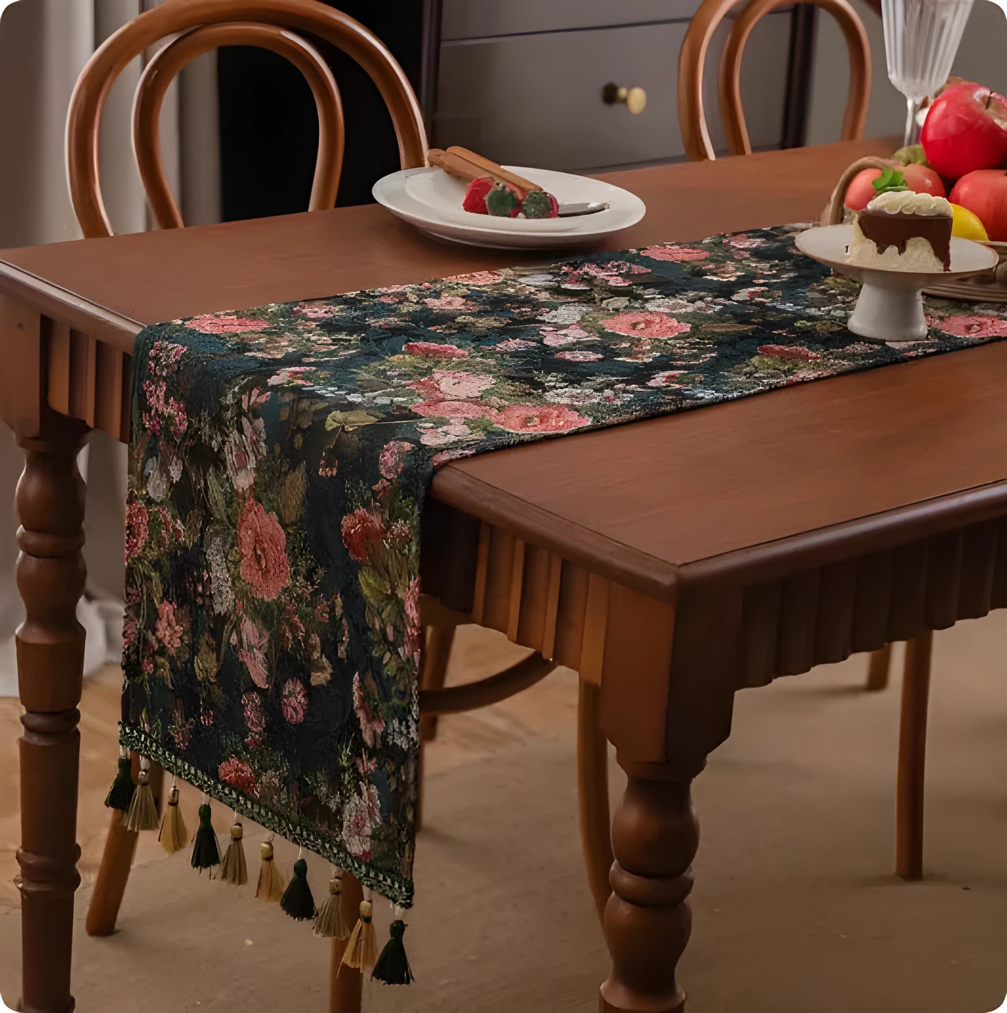 Long blue ginkgo leaf patterned table flag with tassels draped over a wooden sideboard.