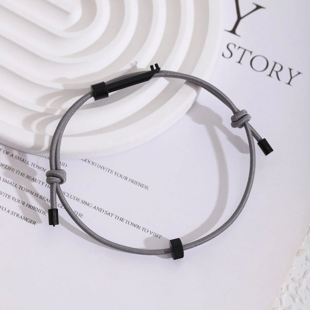 Tungsten carbide adjustable emergency escape bracelet with window breaker tip on grey background
