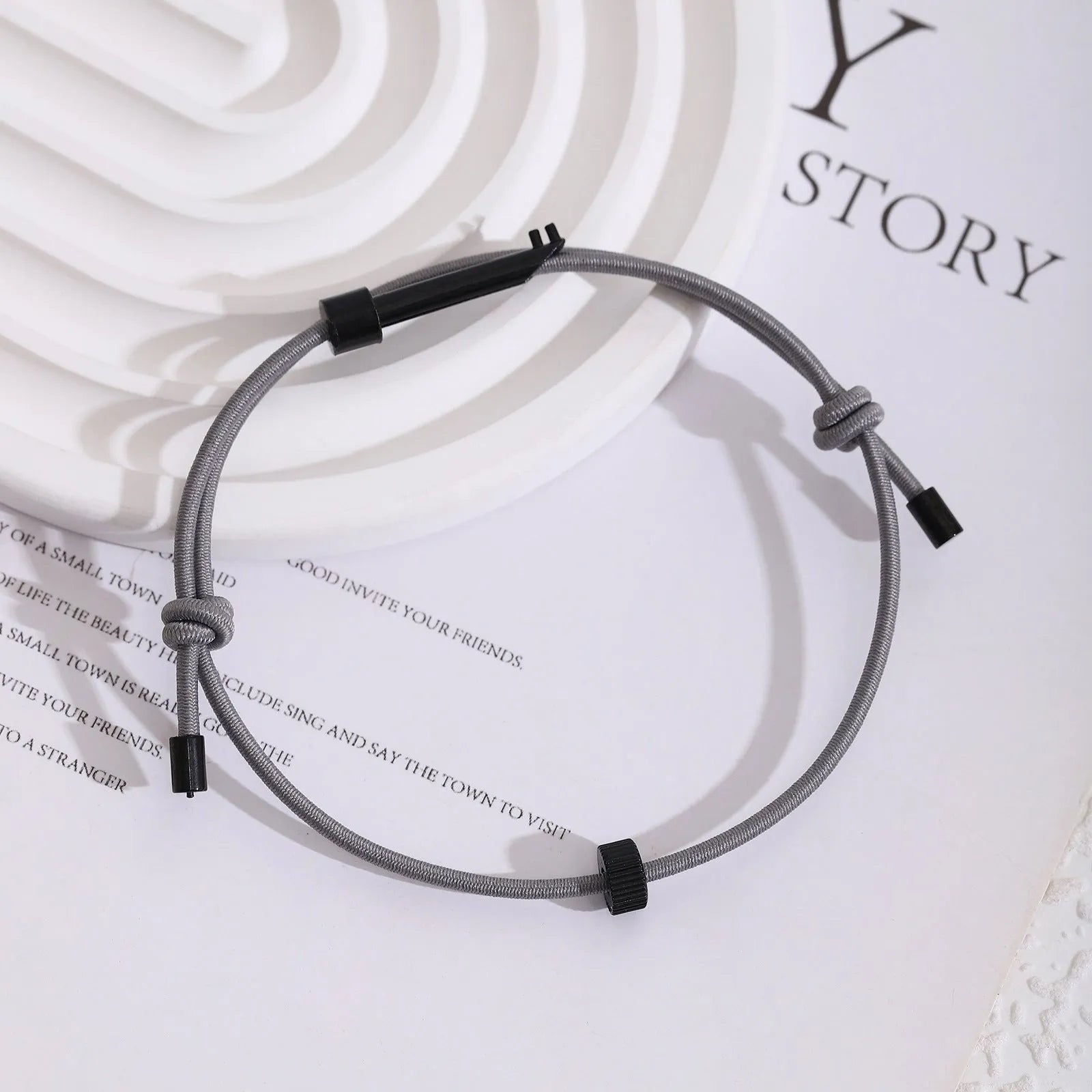 Tungsten carbide adjustable emergency escape bracelet with window breaker tip on grey background