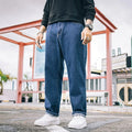 Men's loose fit straight leg casual jeans in dark blue, shown on a hanger.