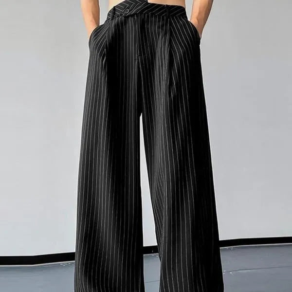 Man wearing black vertical striped pleated casual trousers with an elasticated waistband.