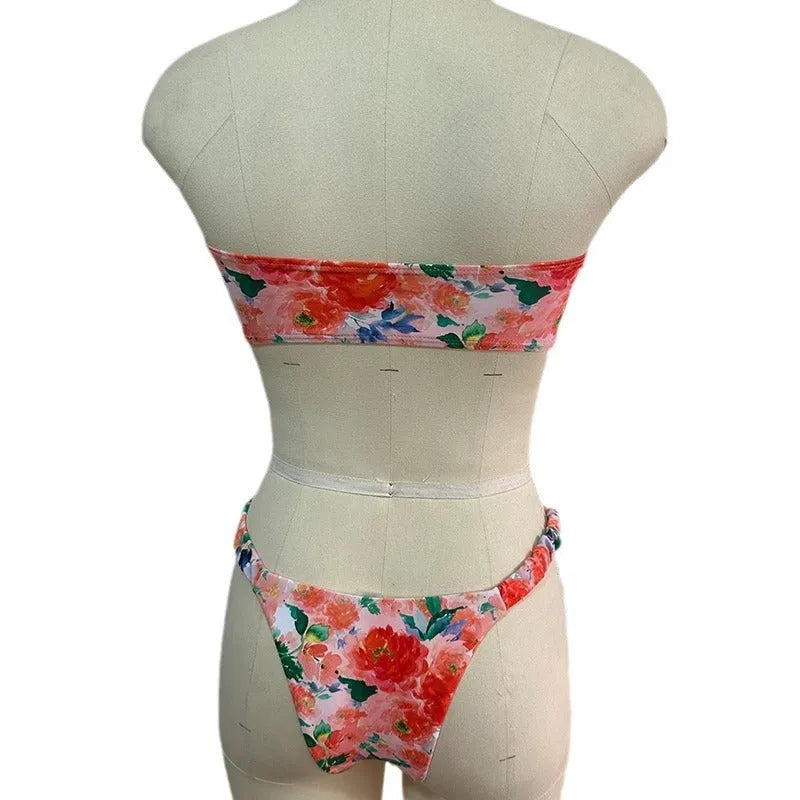 Colourful floral print bikini set with tube top and briefs on a hanger.