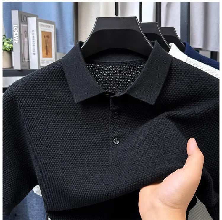 Man wearing a loose fit grey cotton short sleeve sweater, casual pullover style