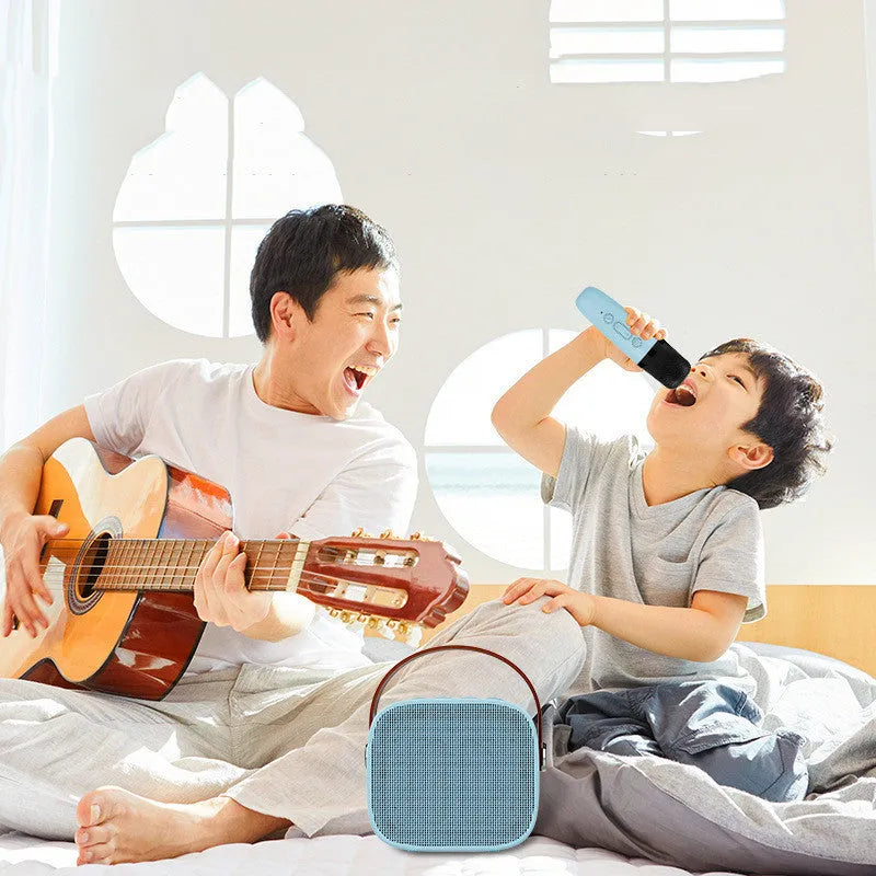 Compact white, pink, or blue plastic portable Bluetooth speaker with microphone on a surface.