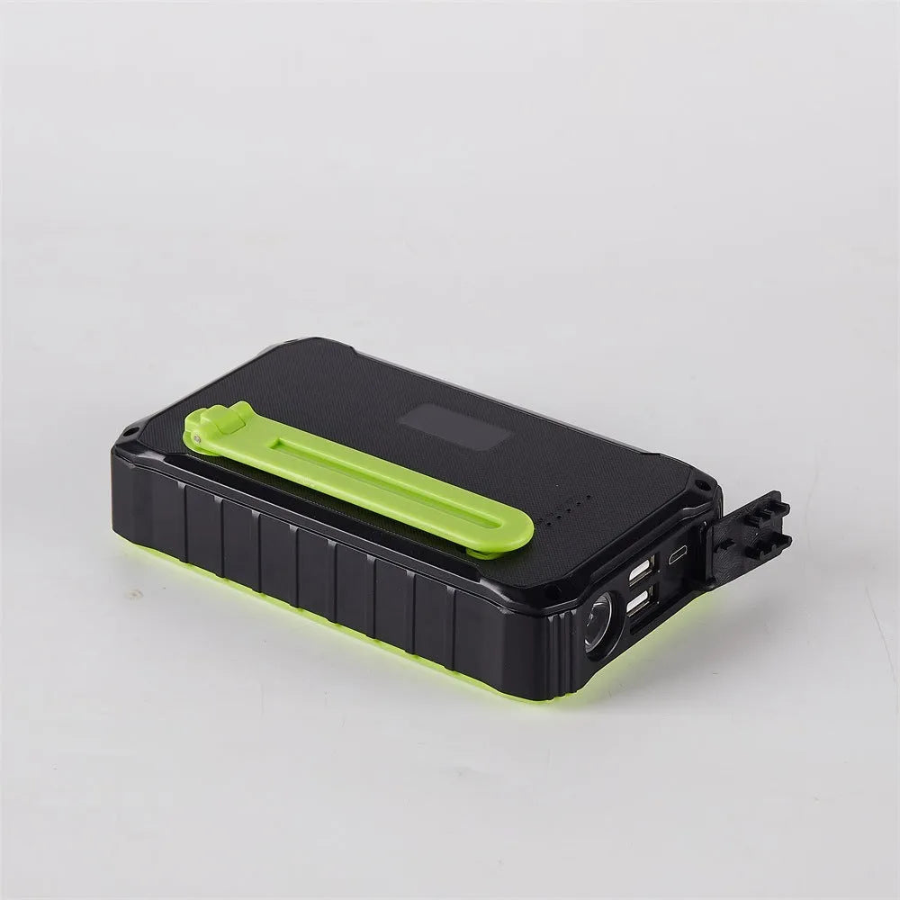 Orange hand solar mobile power bank showing USB ports, solar panel, and hand charging mechanism