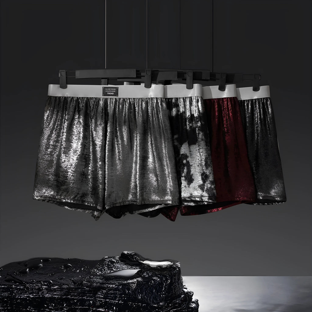 Men's bright silver woven underwear with reflective galaxy pattern showing loose fit mid-waist design