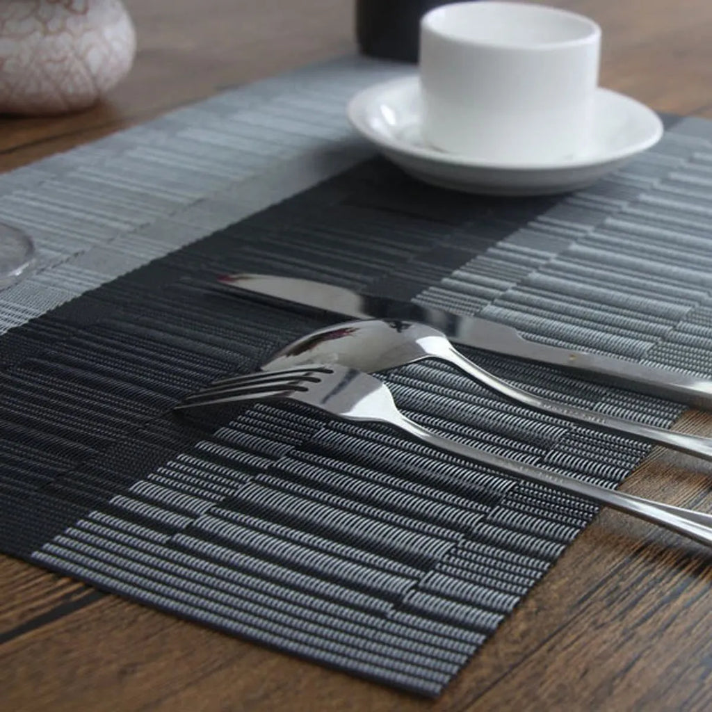 Non-slip PVC dish mat in gradient bamboo pattern protecting a kitchen countertop.