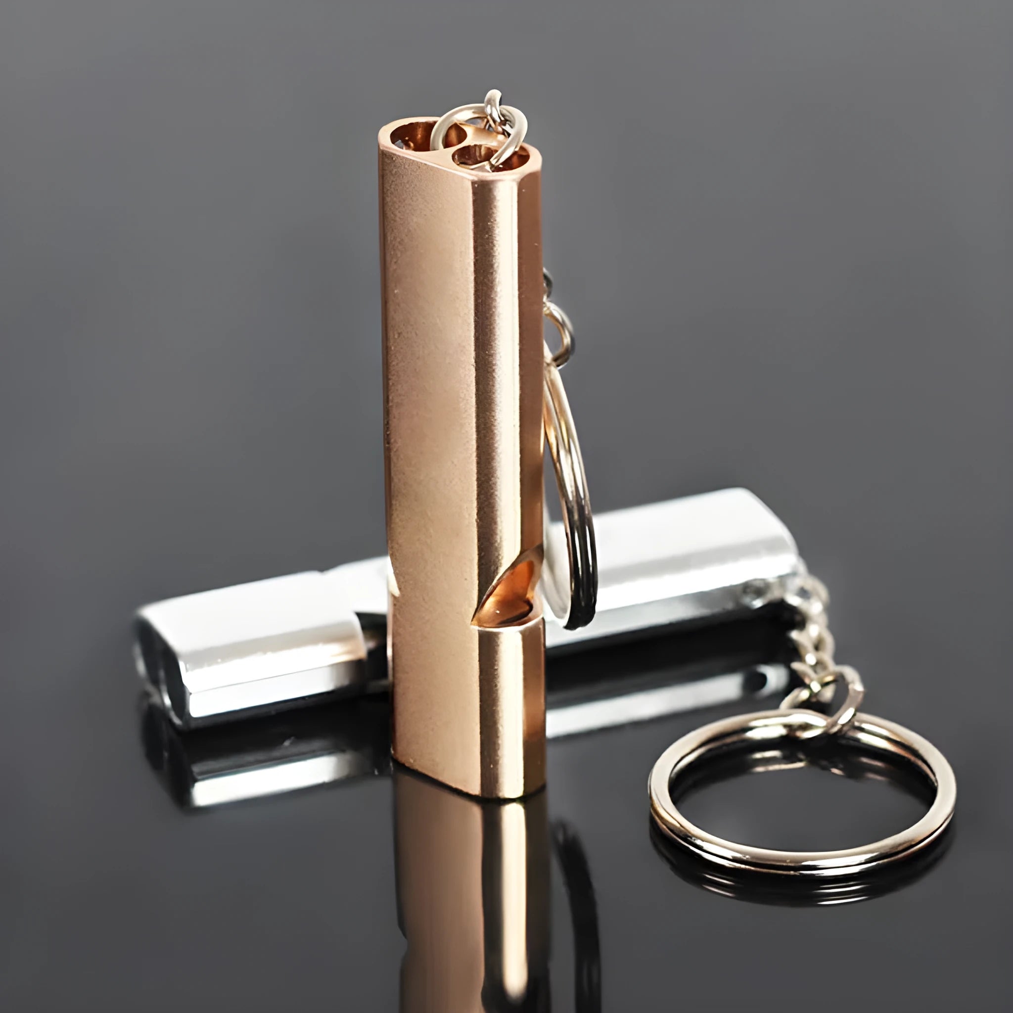 Silver and gold aluminium alloy double hole outdoor survival whistle.