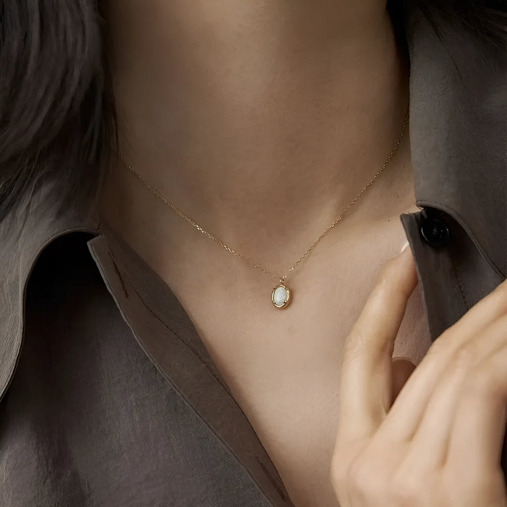 Oval geometric jelly opal pendant necklace in sterling silver with gold or white gold plating.