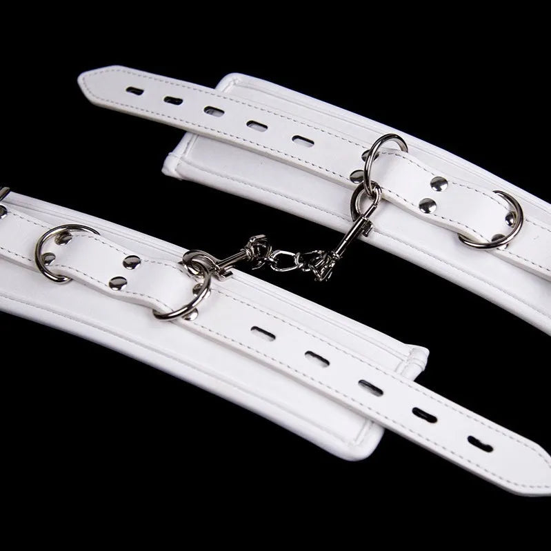 White PU sponge BDSM bondage set showing handcuffs, foot cuffs, and a neck scarf.